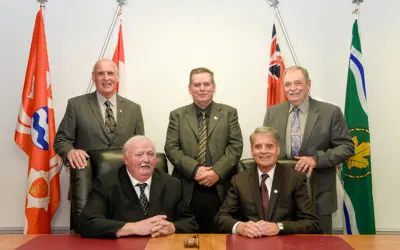The mayor and council posing in Council Chambers