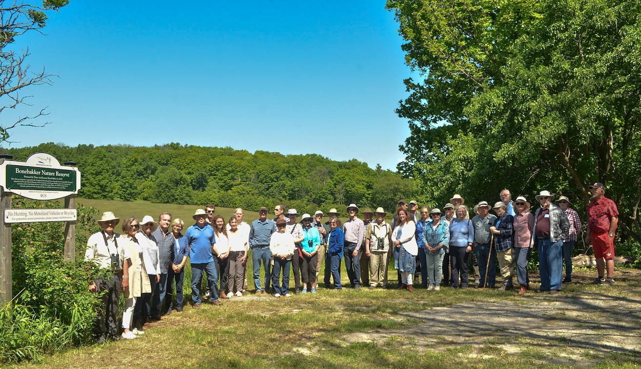 members of the Northumberland Land Trust gather at the sign