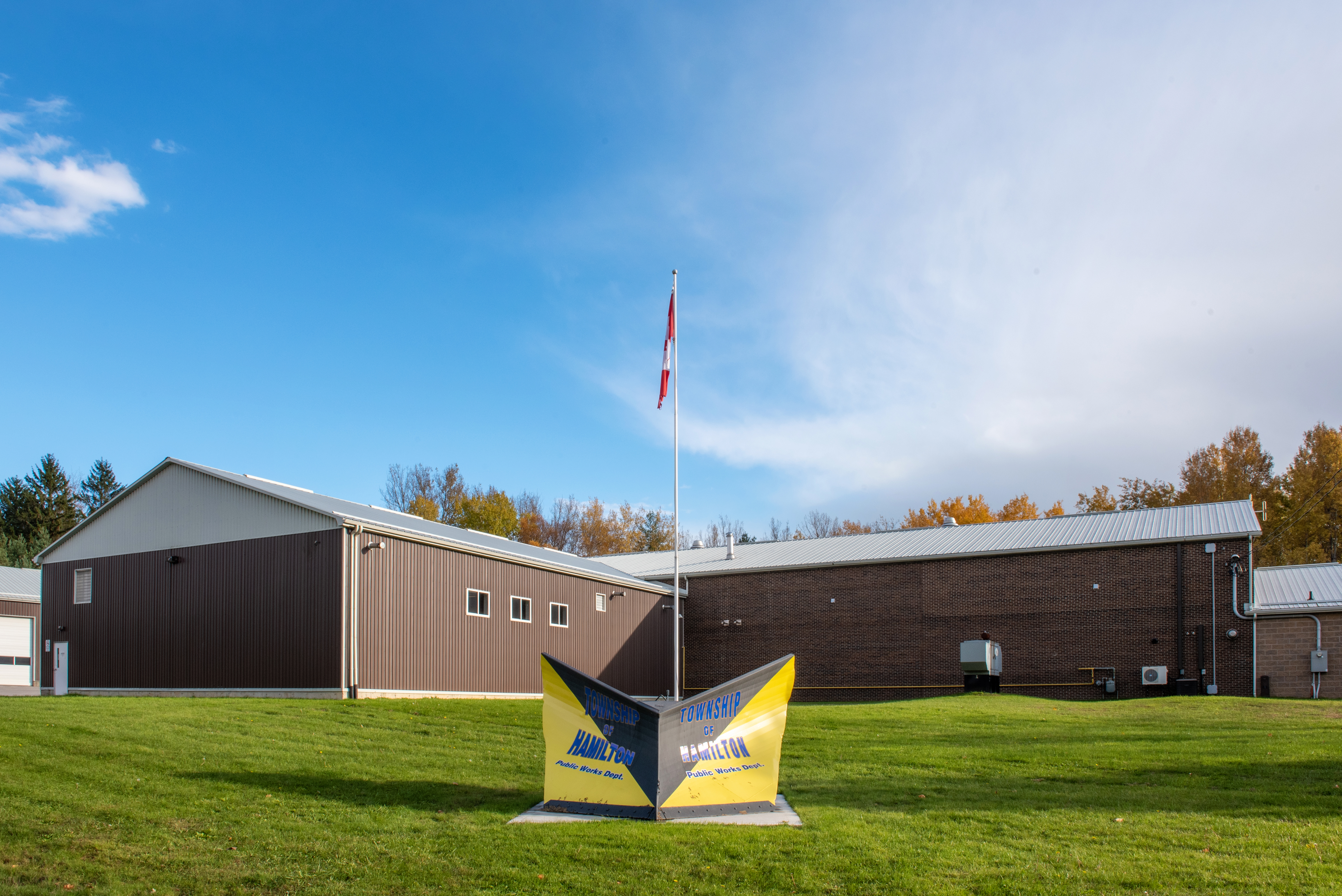 Township of Hamilton Public Works Department building with a plow painted into a Public Works sign