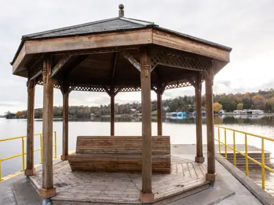 gazebo with wooden bench facing out towards Rice Lake