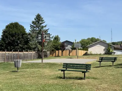 Old Camborne Schoolhouse Playground focused on a basketball court with benches surrounding