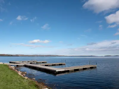 Rice lake marine landscape centered on rows of docks with blue skies and the lake in the background
