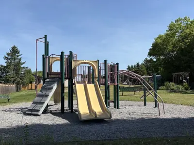 Old Camborne Schoolhouse Playground focused on a climbing structure with slides