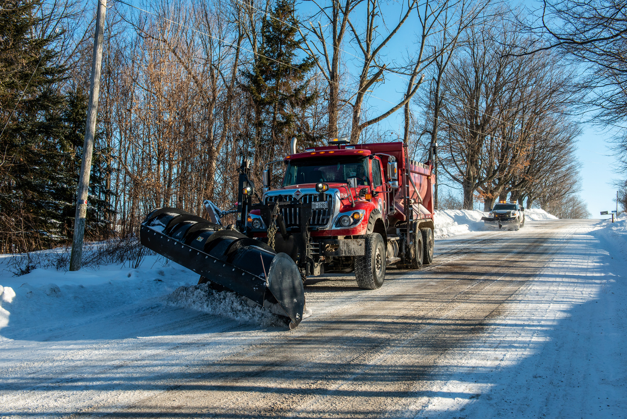 snowplow pushing snow to the side of the roads