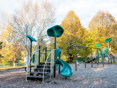 Buttersfield Park with views of two climbing structures and swings