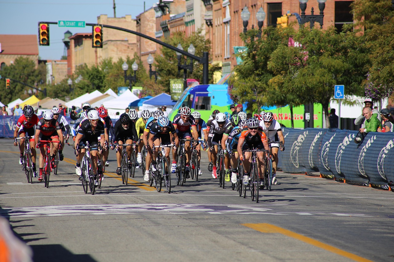 bike race with many contestants moving through a barrier lined street