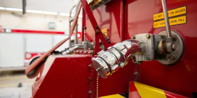 fire truck focused on the valve where the fire hose connects