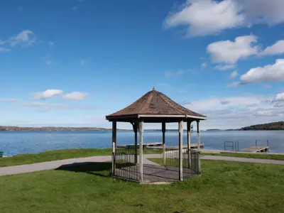 small waterfront gazebo with views of a dock and calm Rice Lake