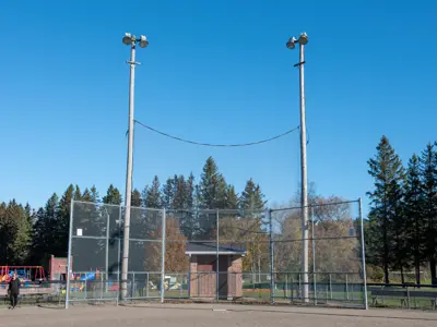 front view of Baltimore arena baseball diamond with batting cage and two large field lights in the background